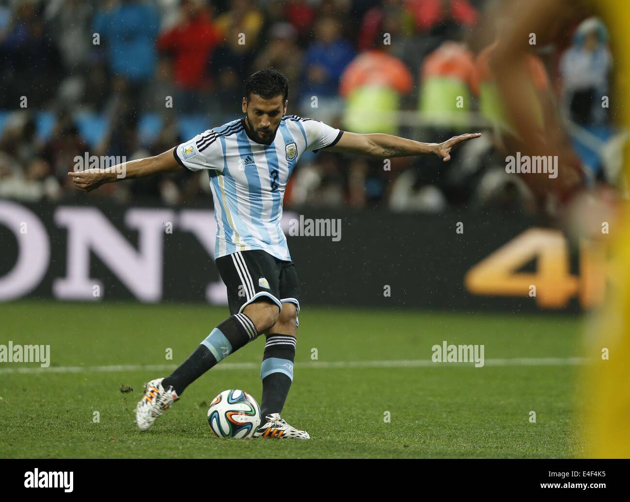 Sao Paulo, Brazil. 9th July, 2014. Argentina's Ezequiel Garay shoots a penalty goal in the penalty shoot-out during a semifinal match between Netherlands and Argentina of 2014 FIFA World Cup at the Arena de Sao Paulo Stadium in Sao Paulo, Brazil, on July 9, 2014. Argentina won 4-2 on penalties over Netherlands after a 0-0 tie and qualified for the final on Wednesday. Credit:  Wang Lili/Xinhua/Alamy Live News Stock Photo