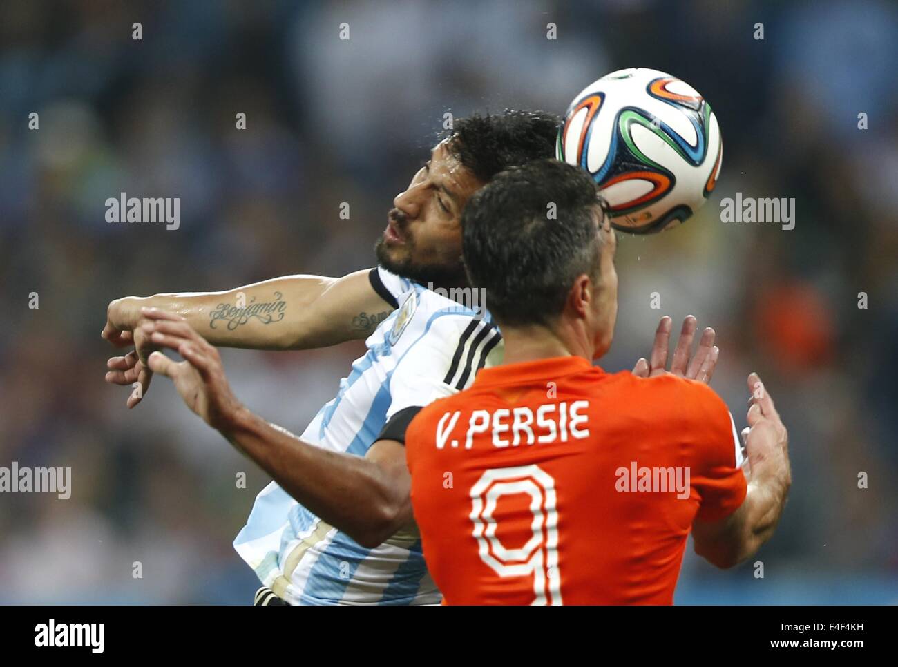 Sao Paulo, Brazil. 9th July, 2014. Argentina's Ezequiel Garay (L) vies with Netherlands' Robin van Persie during a semifinal match between Netherlands and Argentina of 2014 FIFA World Cup at the Arena de Sao Paulo Stadium in Sao Paulo, Brazil, on July 9, 2014. Argentina won 4-2 on penalties over Netherlands after a 0-0 tie and qualified for the final on Wednesday. Credit:  Wang Lili/Xinhua/Alamy Live News Stock Photo