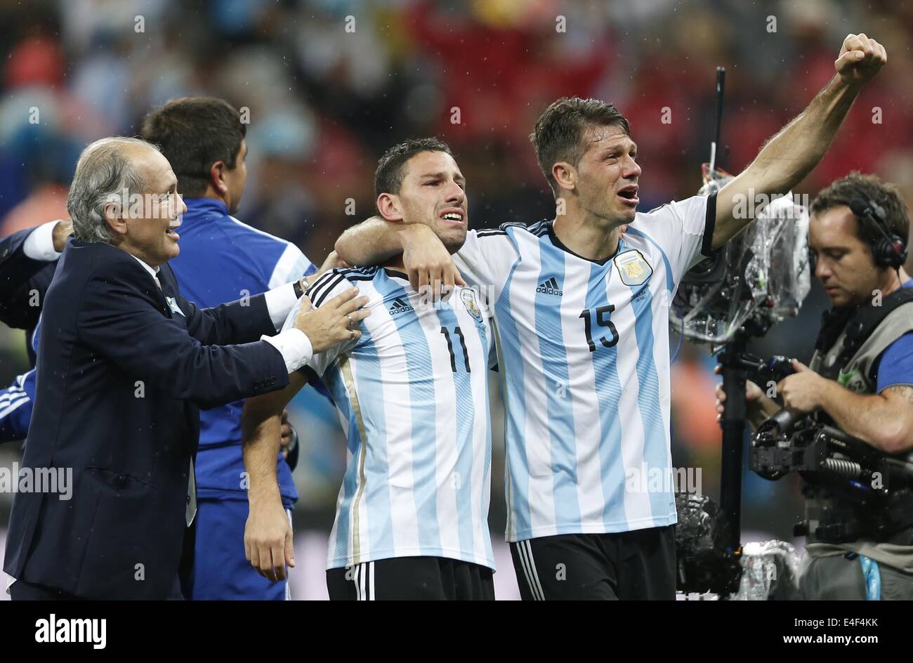 Sao Paulo, Brazil. 9th July, 2014. Argentina's Martin Demichelis, Maxi Rodriguez and coach Alejandro Sabella (R to L, front) celebrate their victory after a semifinal match between Netherlands and Argentina of 2014 FIFA World Cup at the Arena de Sao Paulo Stadium in Sao Paulo, Brazil, on July 9, 2014. Argentina won 4-2 on penalties over Netherlands after a 0-0 tie and qualified for the final on Wednesday. Credit:  Wang Lili/Xinhua/Alamy Live News Stock Photo