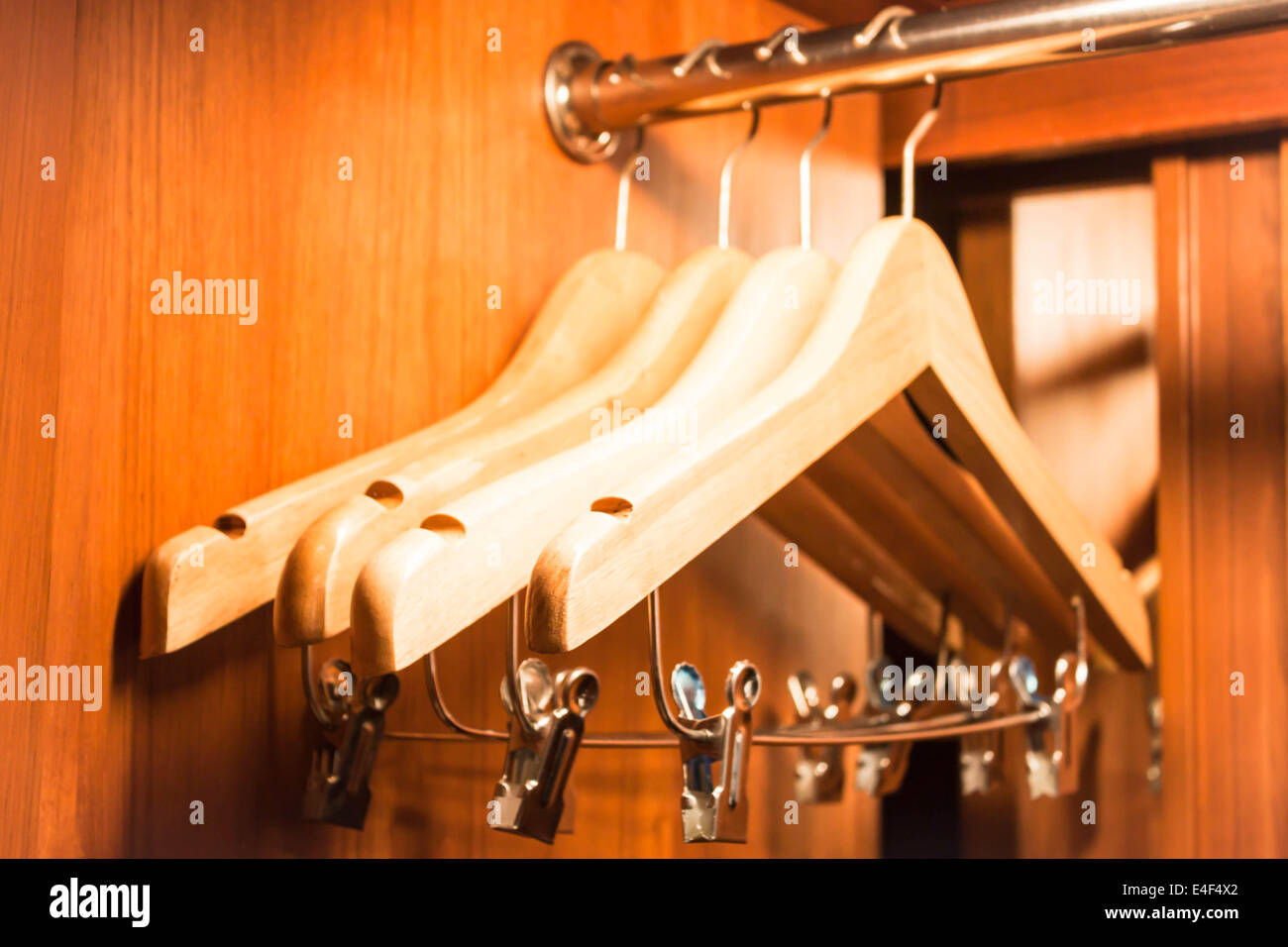 Wooden hanger hanging in a wood closet Stock Photo Alamy