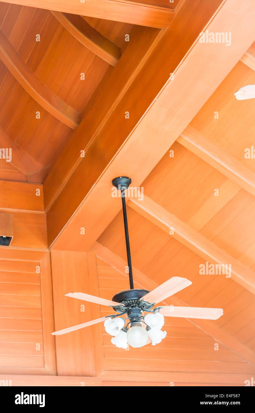Hanging wood ceiling fan with glass lamps Stock Photo