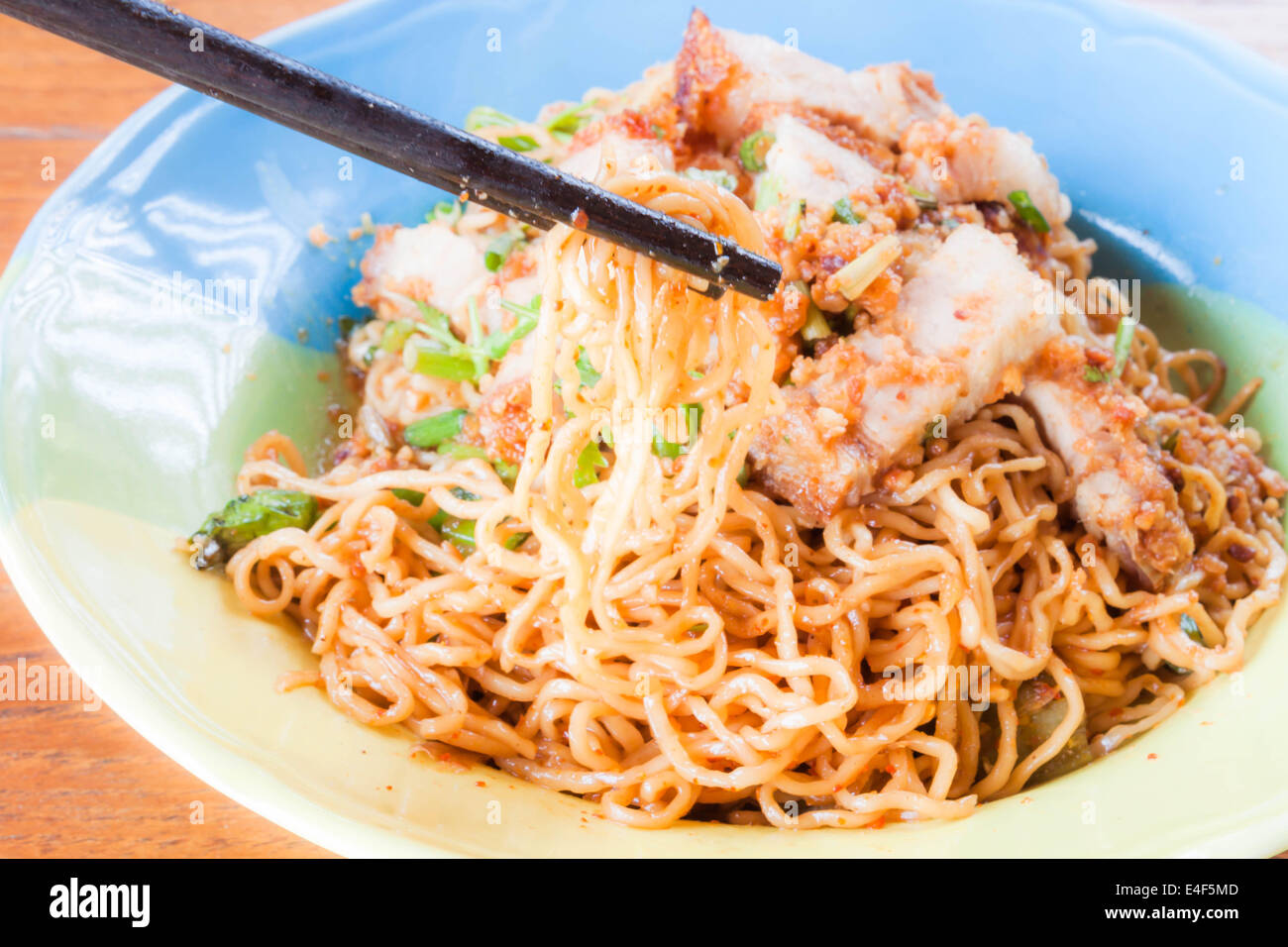 Chopstick holding yellow noodles from spicy noodles Stock Photo Alamy