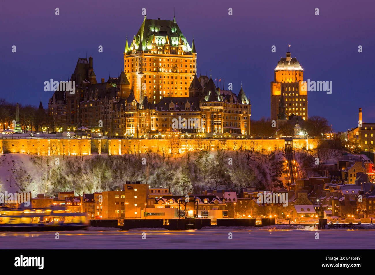 City skyline at twilight, showing Chateau Frontenac in winter, as seen from across the Saint Lawrence River, Quebec City Quebec, Stock Photo