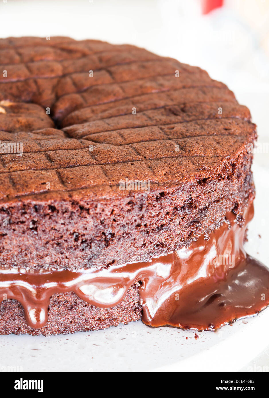 Chocolate fillings melt from middle layer of chocolate cake Stock Photo