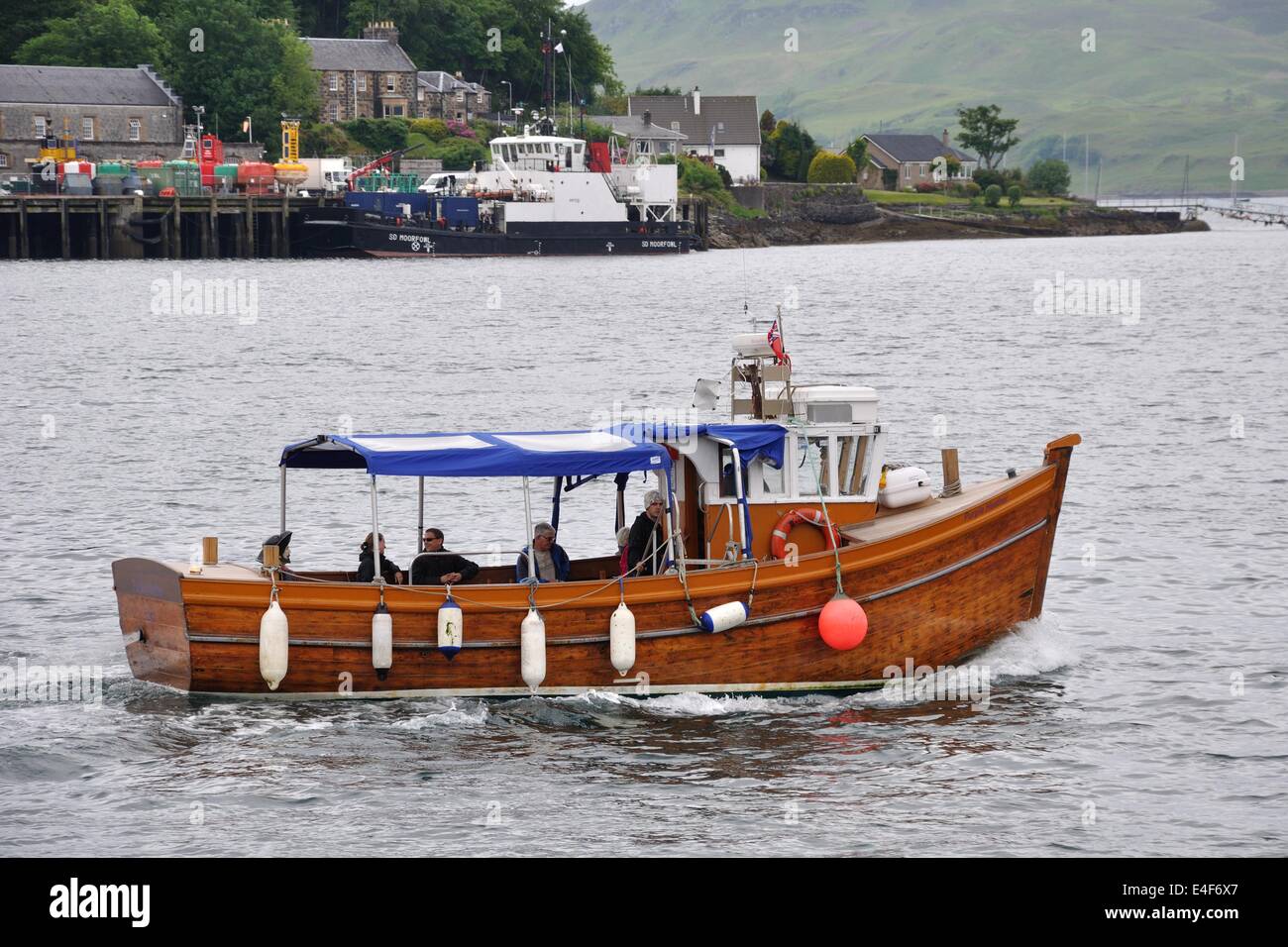 Small boat takes tourists to see the seal colony in Oban bay, Scotland. Stock Photo