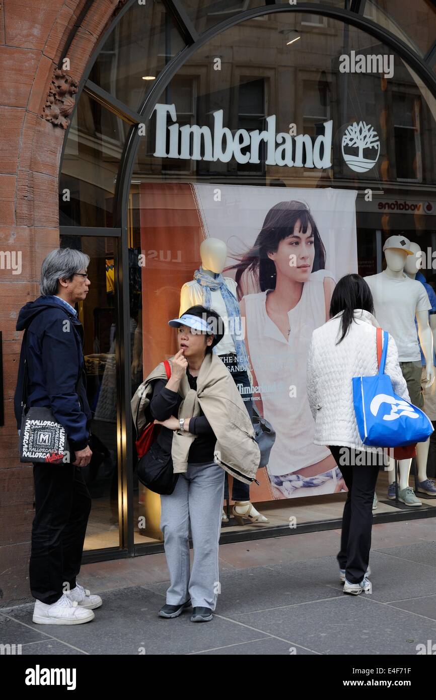 Asian man and woman outside a Timberland shop in Glasgow, Scotland, UK  Stock Photo - Alamy