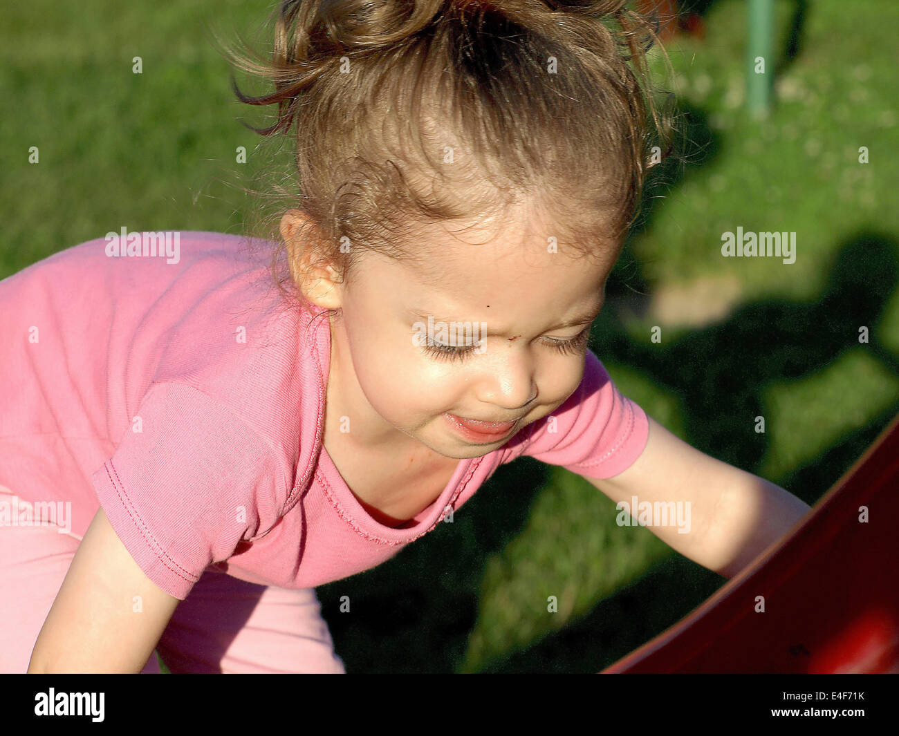 adorable little girl playing in the park Stock Photo - Alamy