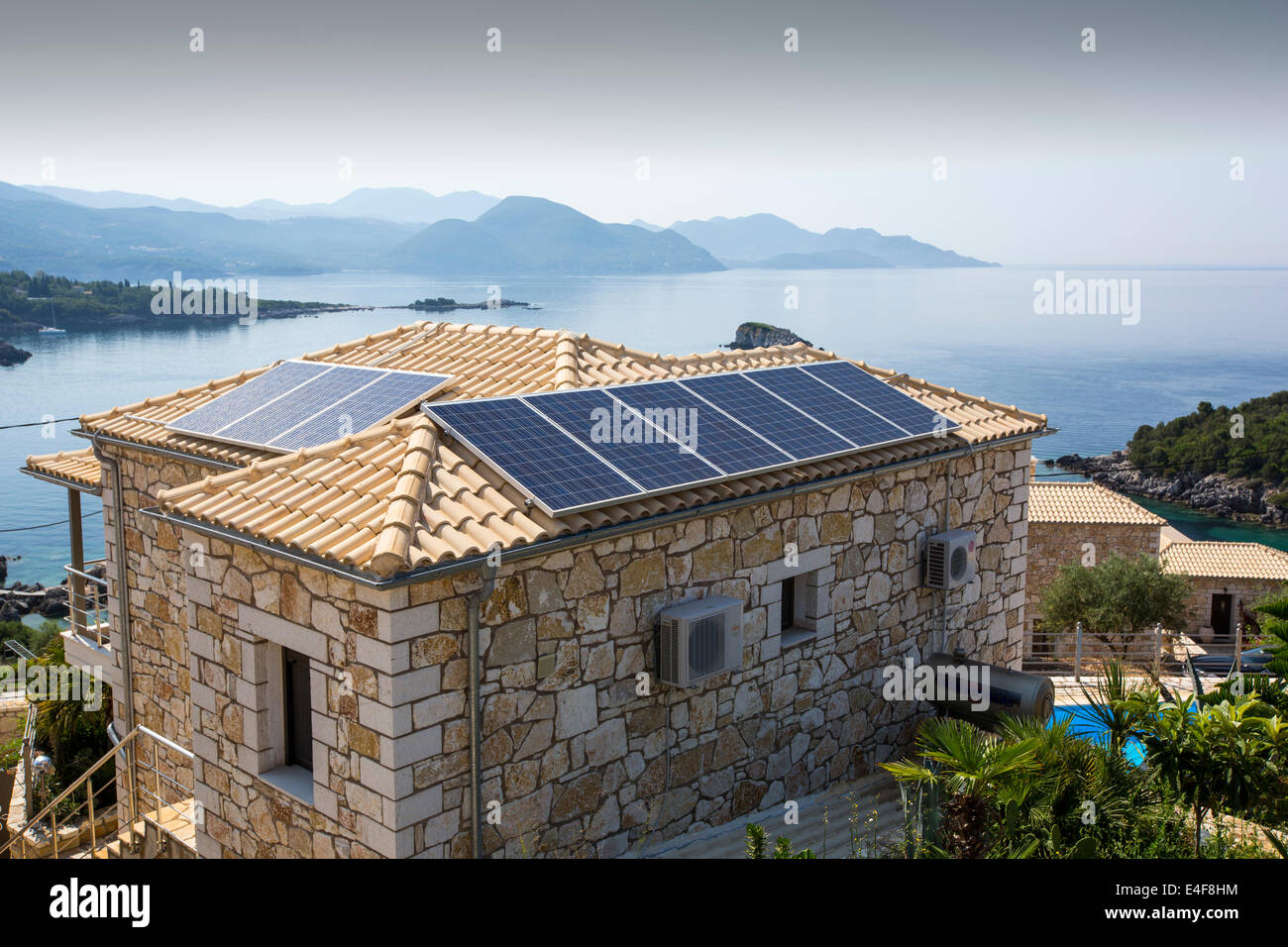 Solar panels on a house roof in Sivota, Greece. Stock Photo