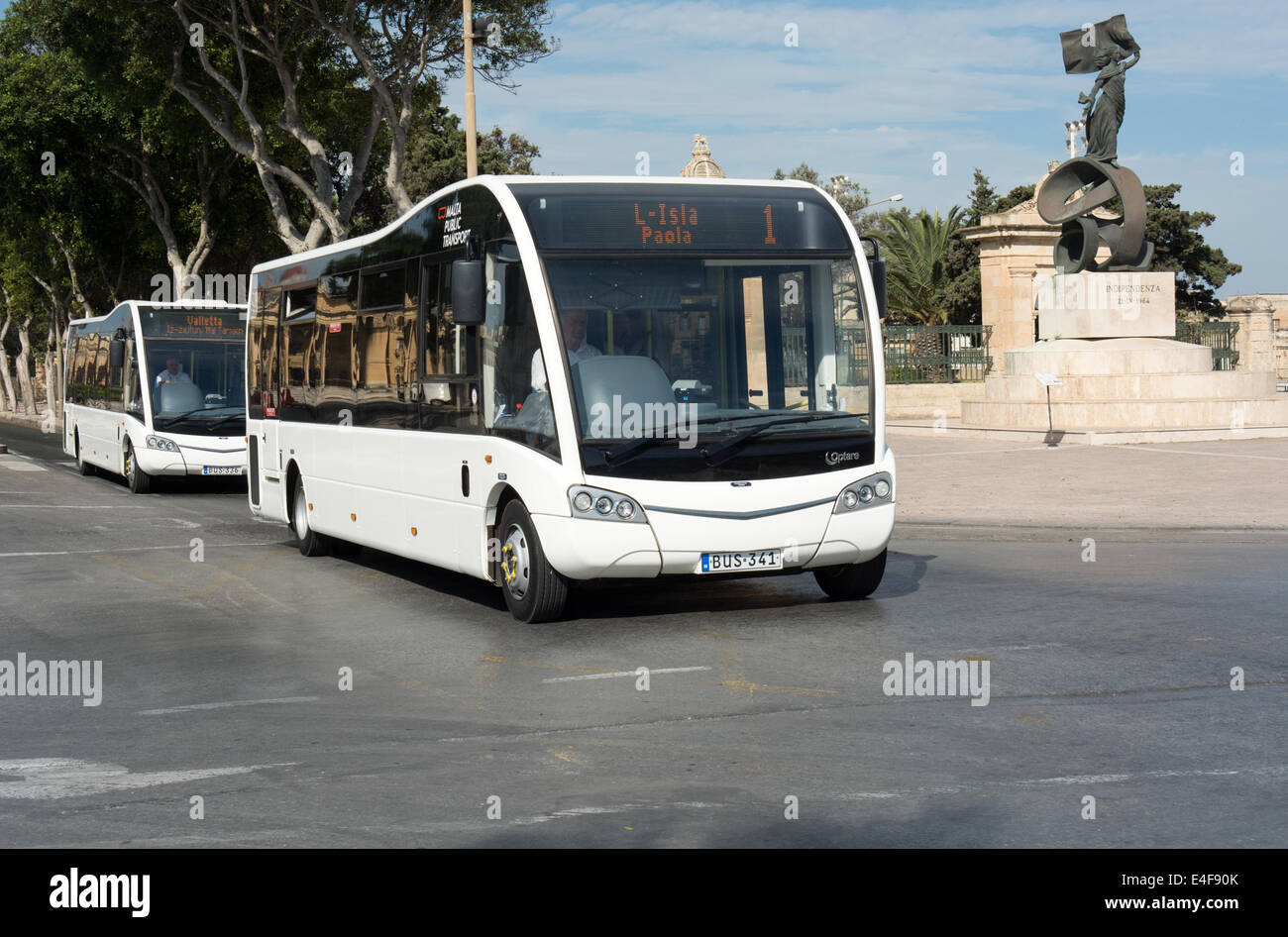 Two of the Optare Solos leased to Malta Public Transport in June 2014. It is passing a statue marking Malta's independence Stock Photo