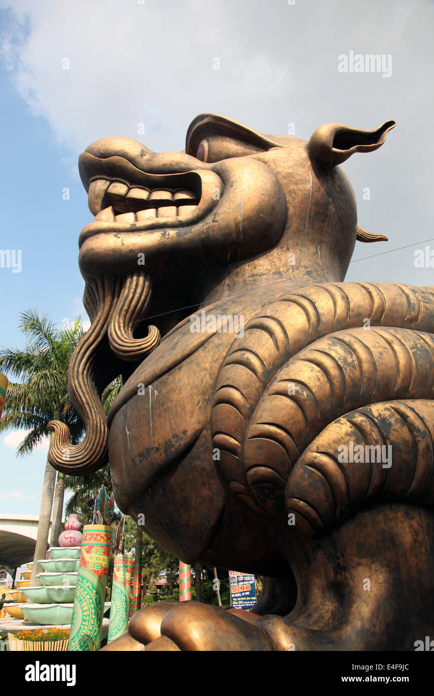 It's a photo of a profile of a Dragon Statue or sculpture in Bronze in a park in Vietnam. We see the head only, not the fully on Stock Photo