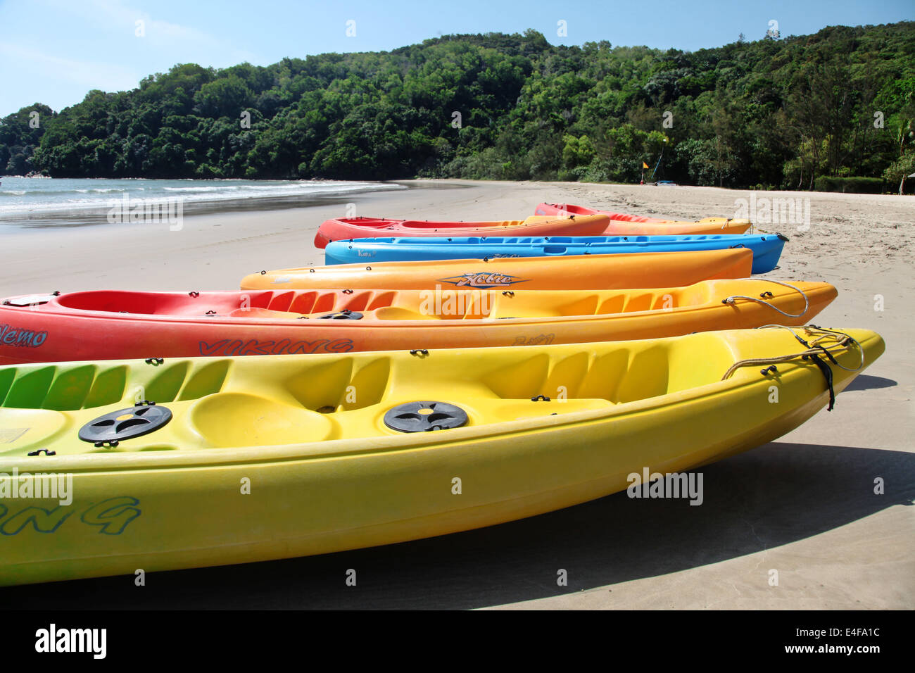 It's a picture of canoe on the beach. It's for water sport activity. Orange color. It's in a Water Sport Center near the sea Stock Photo