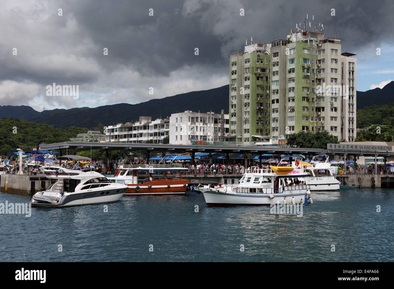 It's a photo of the harbor of Sai Kung in New Territories in Hong Kong, China. We can see boats and the sea Ocean. It's cloudy Stock Photo