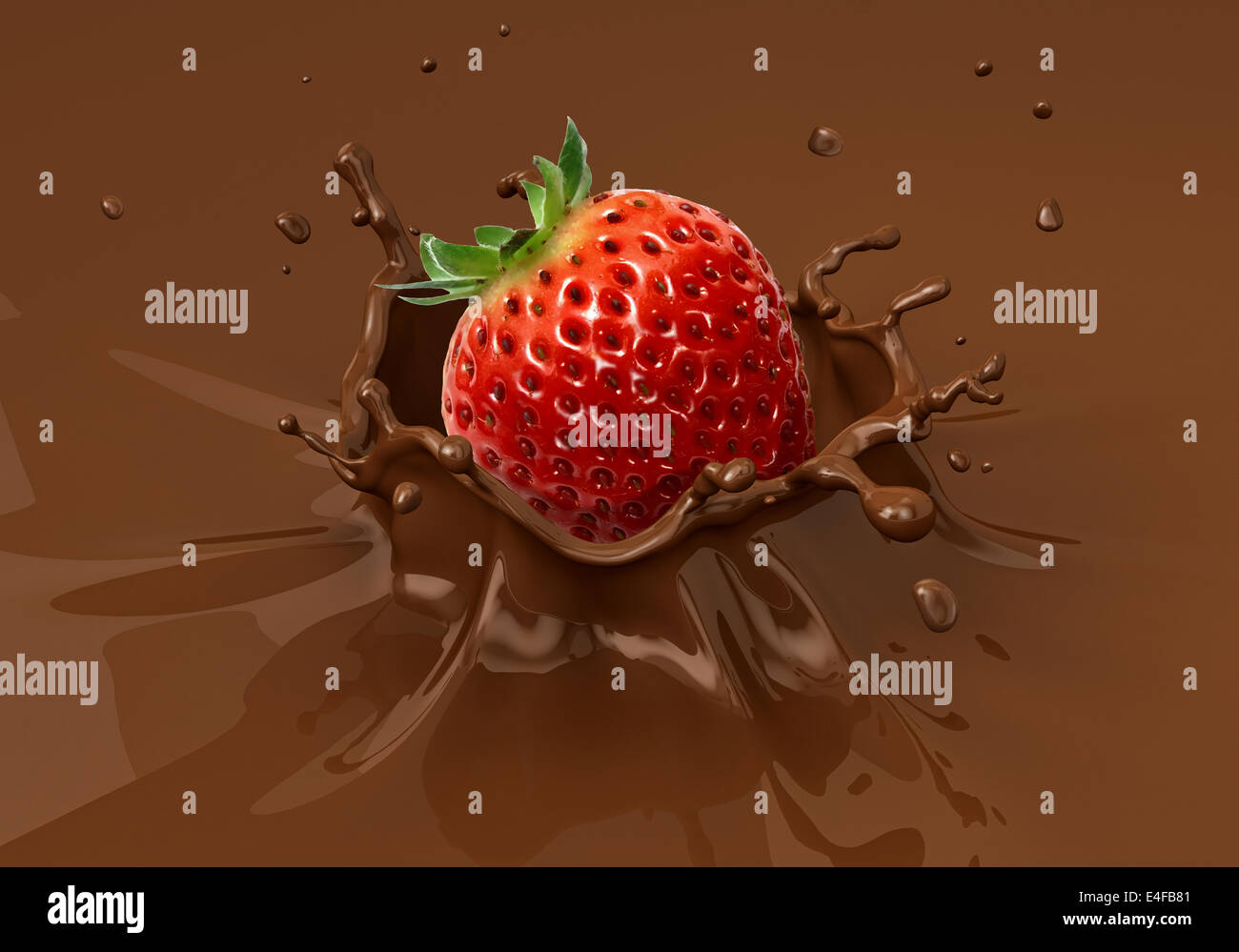 Strawberry falling into liquid chocolate splashing.  Close up view. Stock Photo