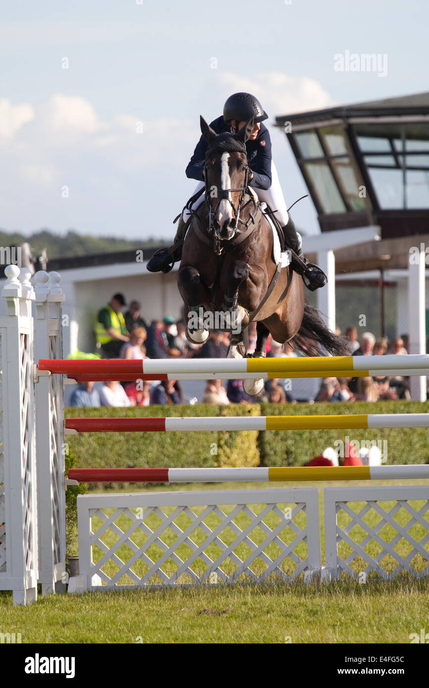 Harrogate, North Yorkshire, UK. 9th July, 2014. A rider clearing a jump during the Rudding Park Great Yorkshire Championship Show Jumping competition at the Great Yorkshire Show on July 9th, 2014 at Harrogate, Yorkshire. Credit:  AC Images/Alamy Live News Stock Photo