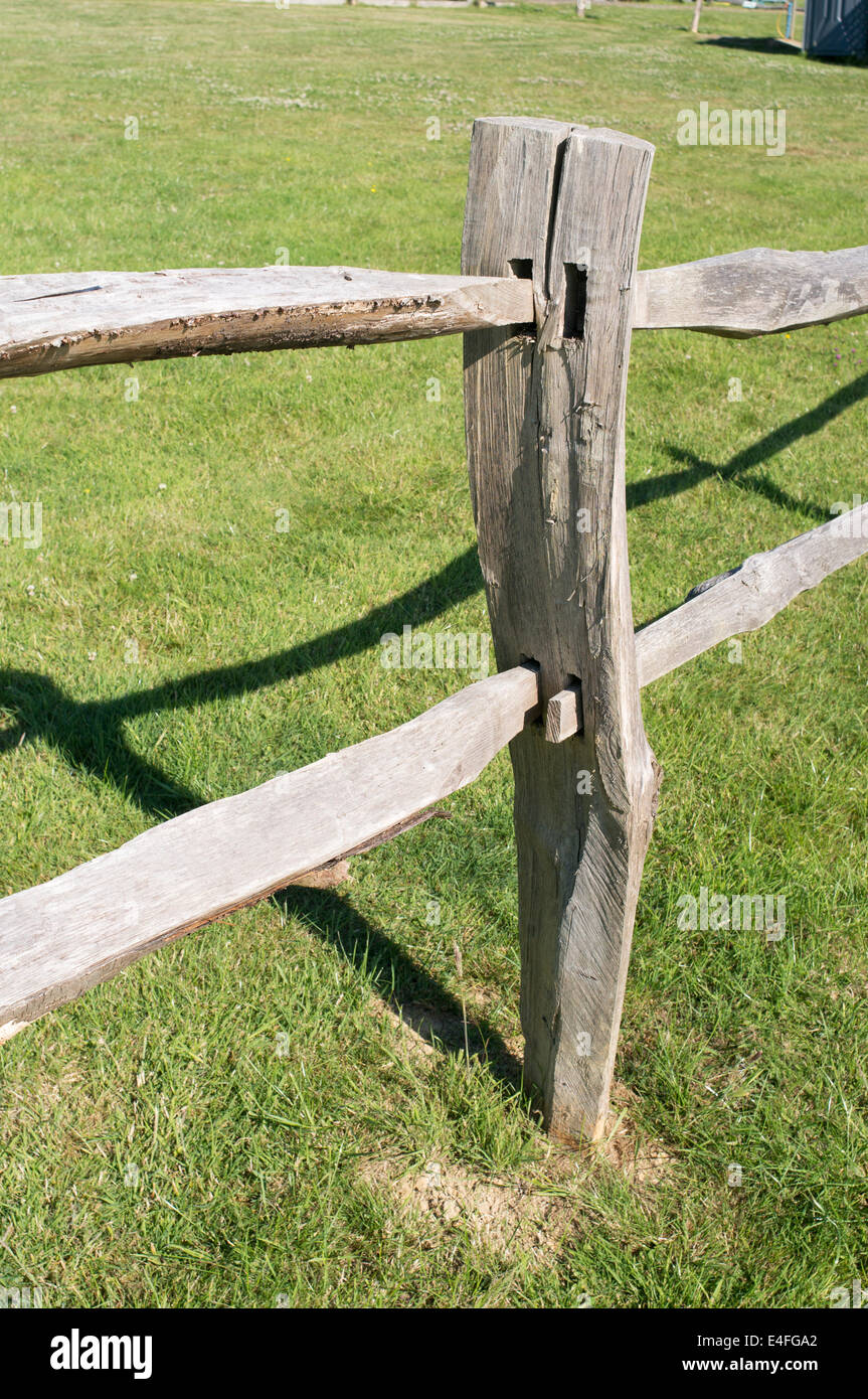 Chestnut timber post and rail fence around field in east Sussex England UK Stock Photo
