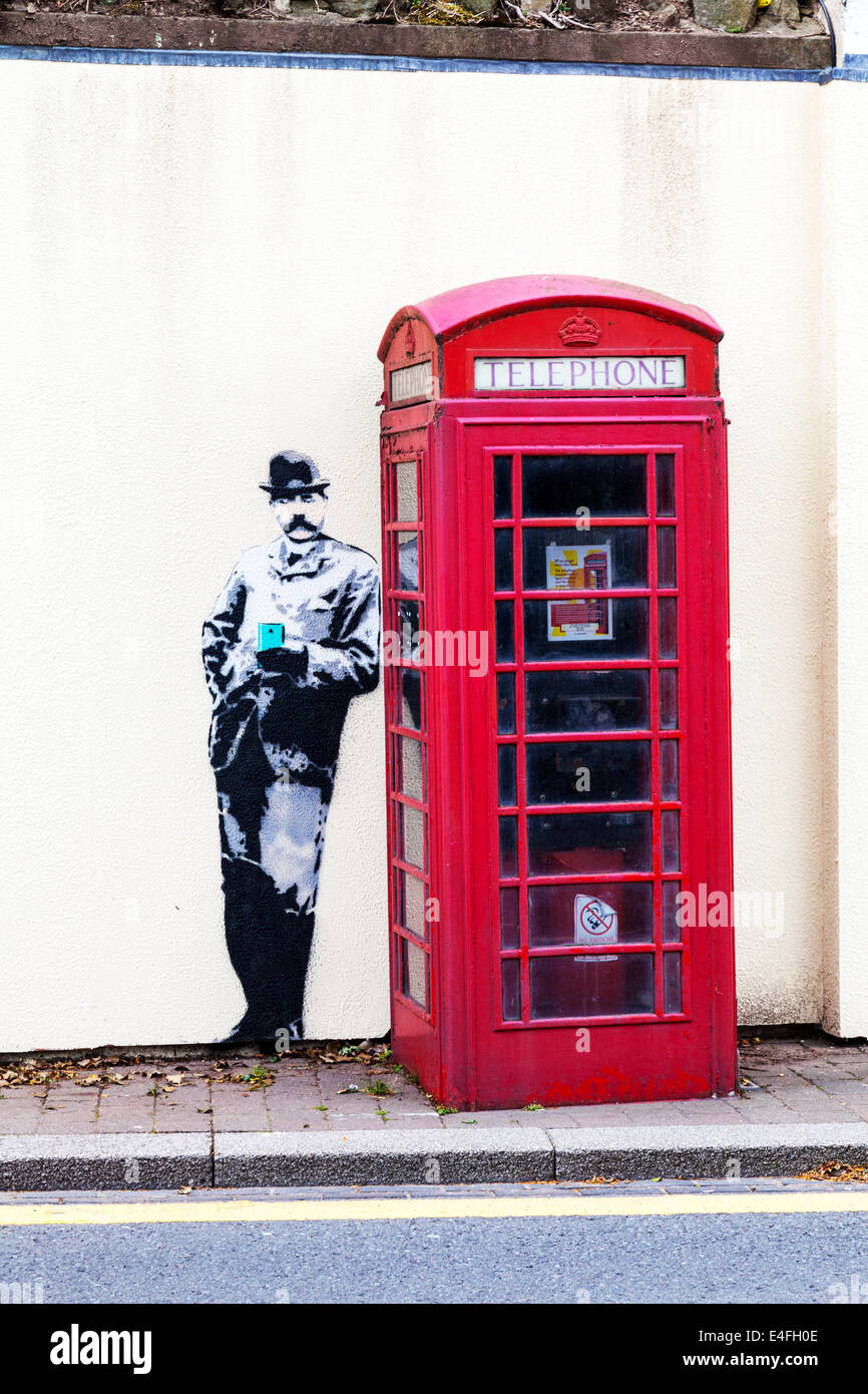 Banksy style mural graffiti red phone box in Great Malvern Worcestershire  UK England Stock Photo - Alamy