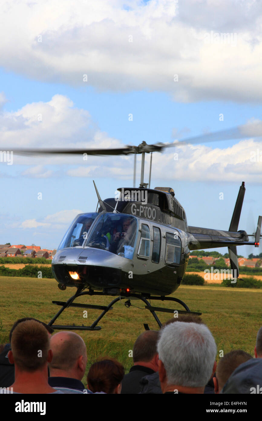 Helicopter pleasure trips, people queuing, Bell Helicopters, rotas running, passenger pick-ups, quick turnaround, hot refuels, bell, ranger, aircraft. Stock Photo