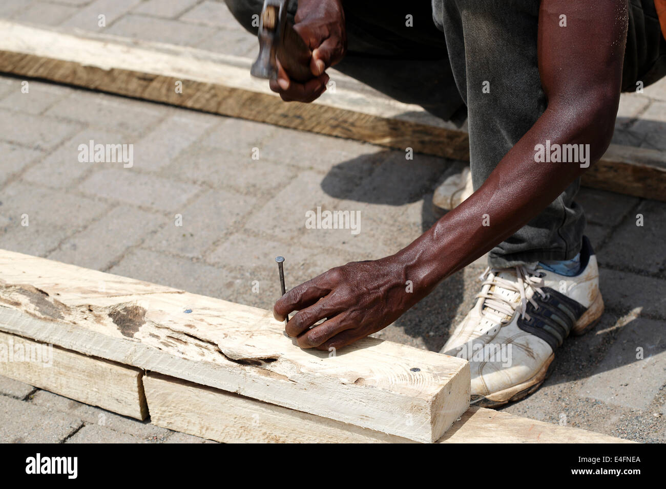 African carpenter works with wood Stock Photo
