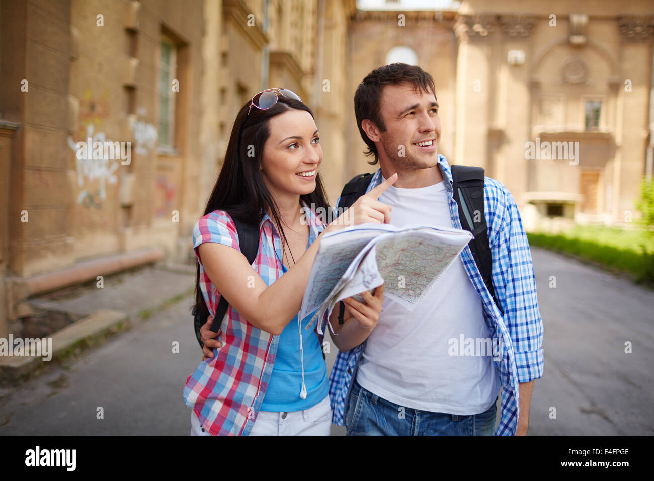 Couple of travelers with map of ancient town deciding where to go Stock Photo
