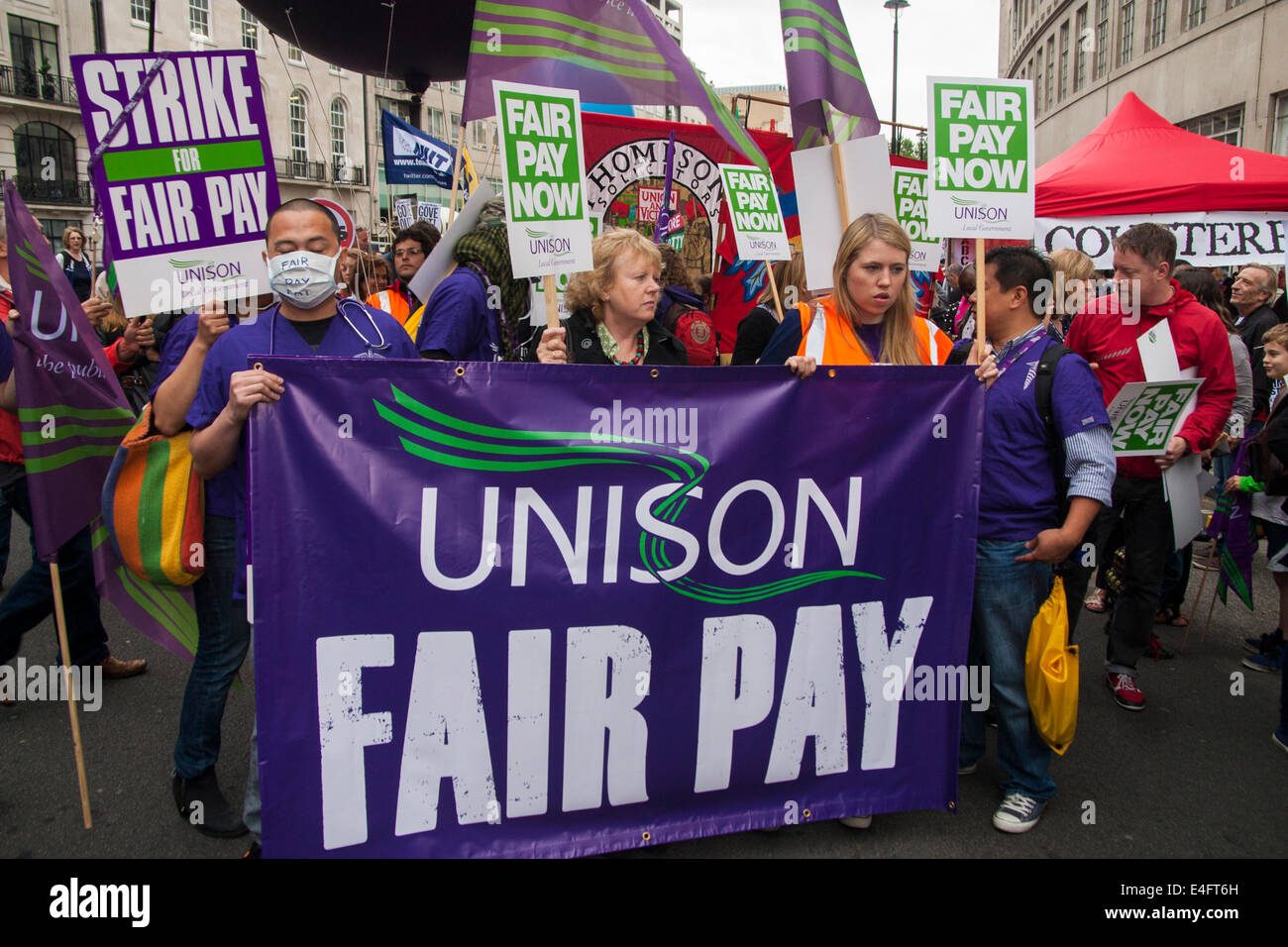 London, UK. 10th July, 2014. Unison protesters demand fair pay as thousands of striking teachers, government workers and firefighters march through London in protest against cuts and working conditions. Credit:  Paul Davey/Alamy Live News Stock Photo