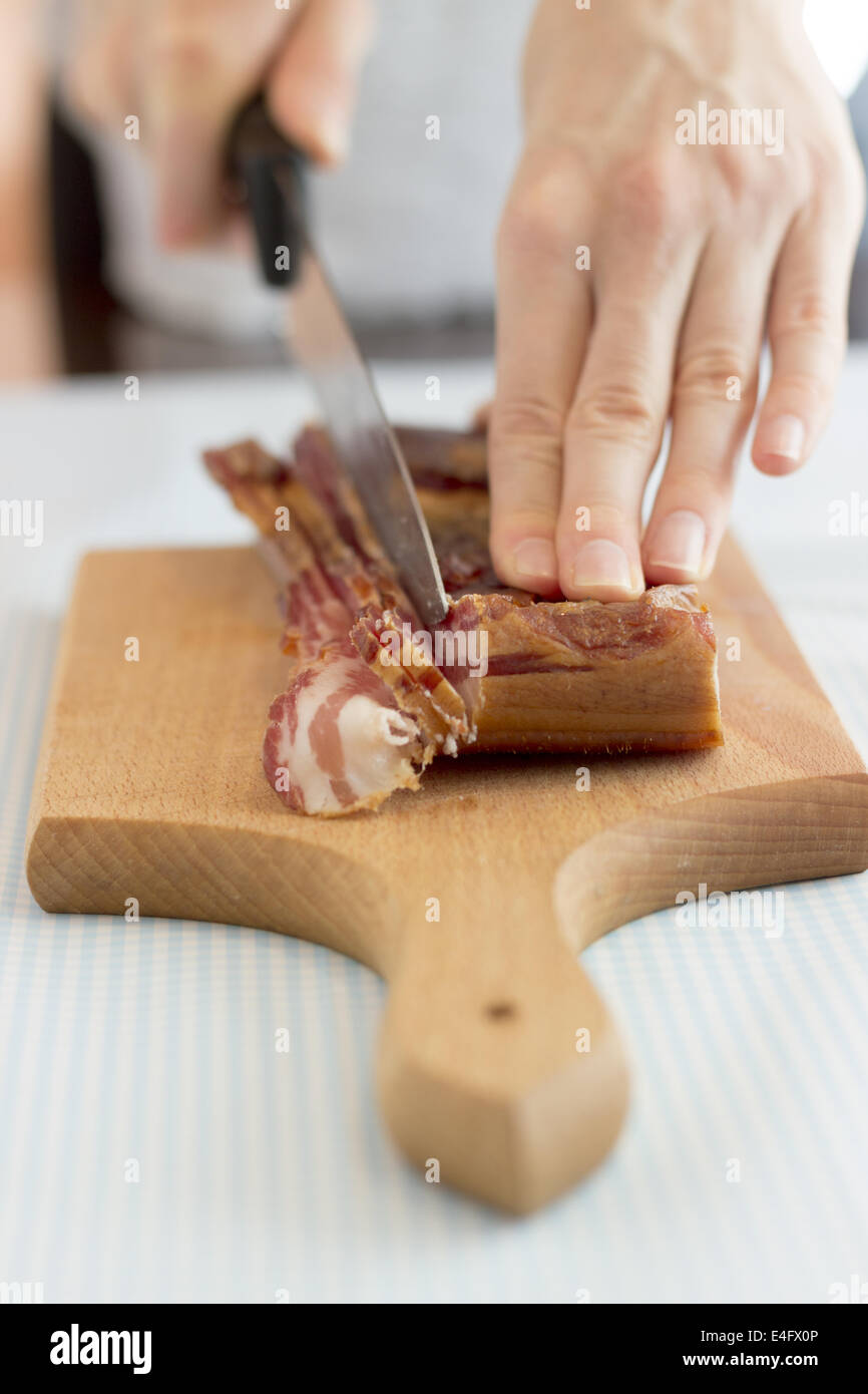 Chef cutting bacon into strips, close up Stock Photo - Alamy
