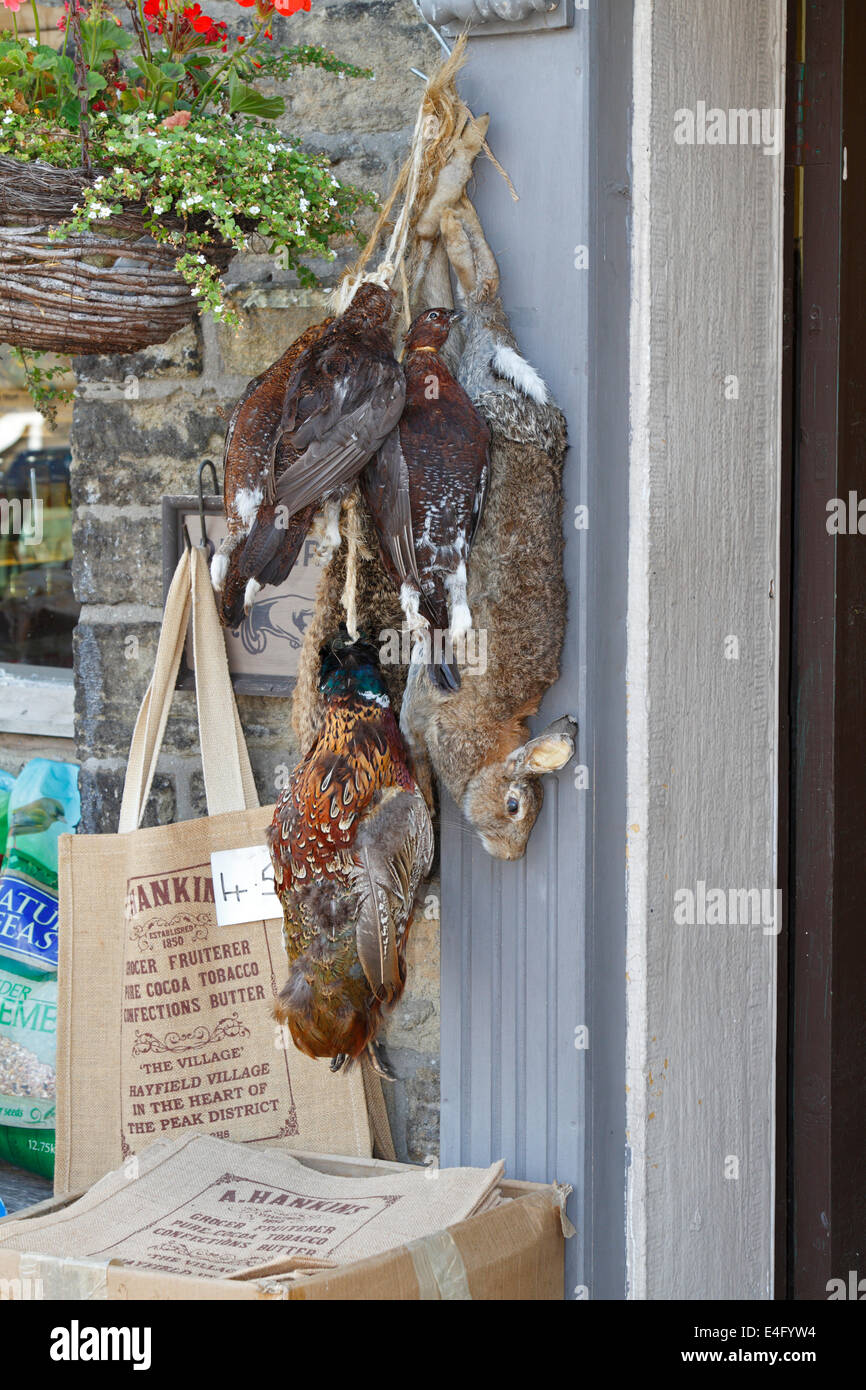 Pheasants and a rabbit hanging up outside Hankins Store in Hayfield, Derbyshire, England, UK. Stock Photo