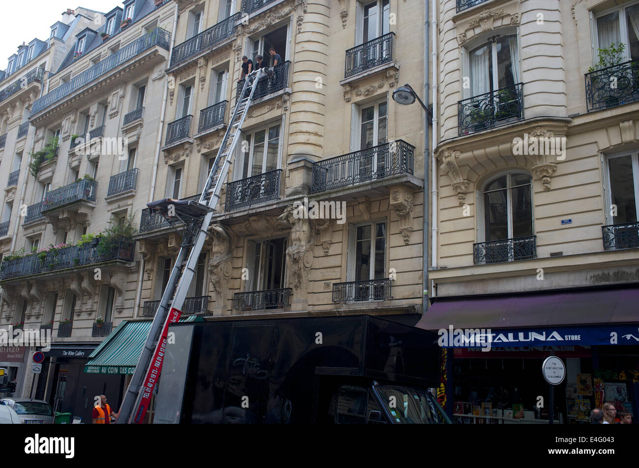 Removals firm using a lift to take furniture to a third storey