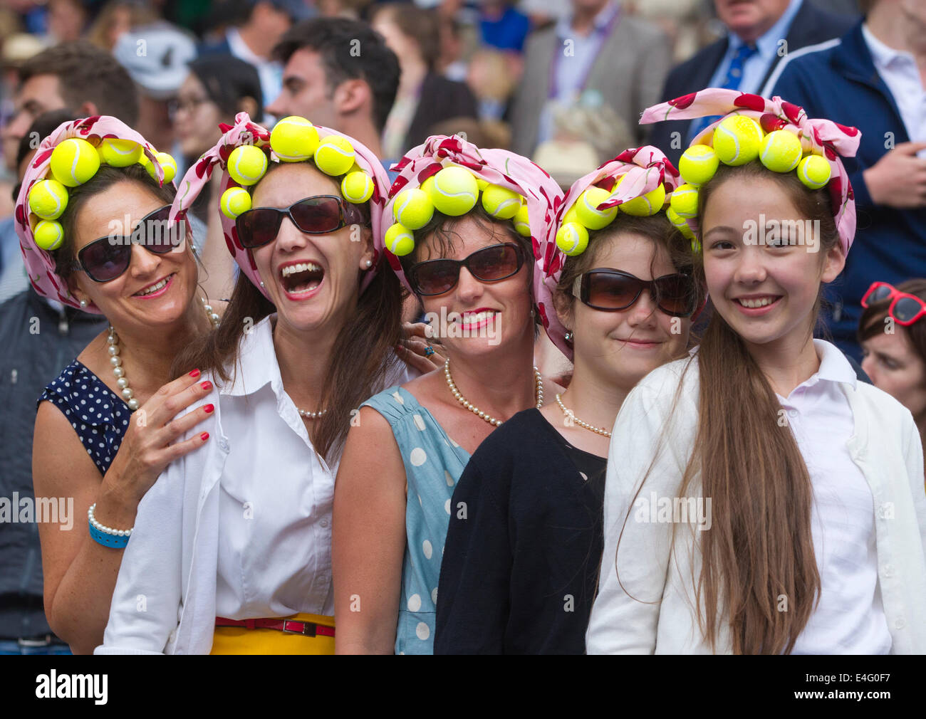 Wimbledon Tennis Championships 2014, tennis enthusiasts wearing themed headwear in auditorium on Centre Court. Stock Photo