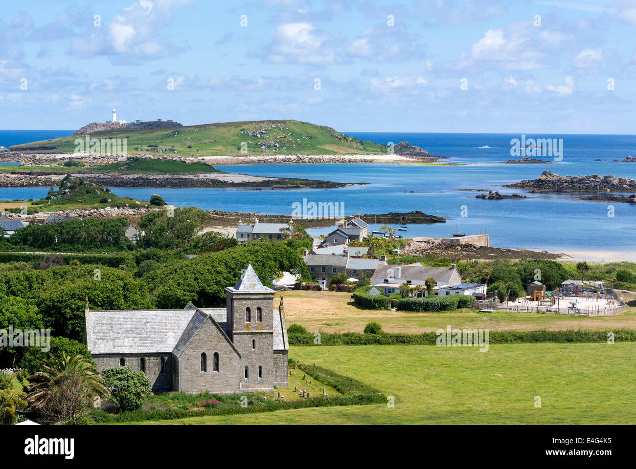 Tresco, Isles of Scilly, Cornwall England.  Looking towards Old Grimsby harbour with St Nicholas church in the foreground. Cornwall England UK. Stock Photo