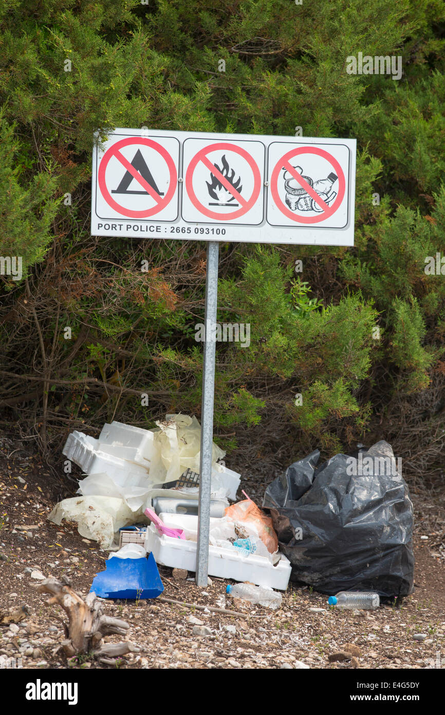The irony of litter being left below a no litter sign in Sivota, Greece. Stock Photo