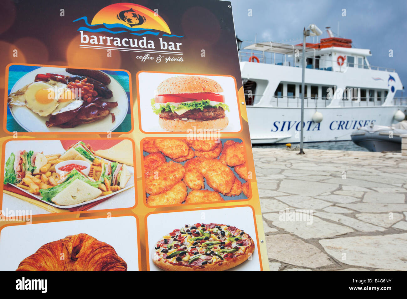 A menu board outside a seafront restaurant in Sivota, Greece. Stock Photo