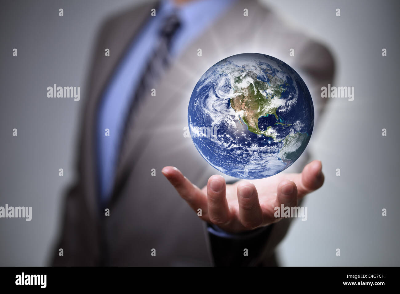 Businessman holding the world in his hands Stock Photo