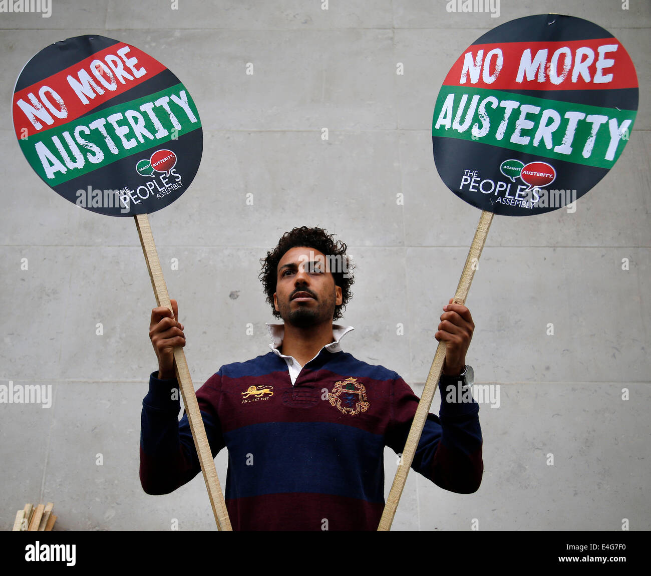 UK, London : A man holds 'No more Austerity' placards during a protest against government cuts in London on 10 July, 2014. Stock Photo