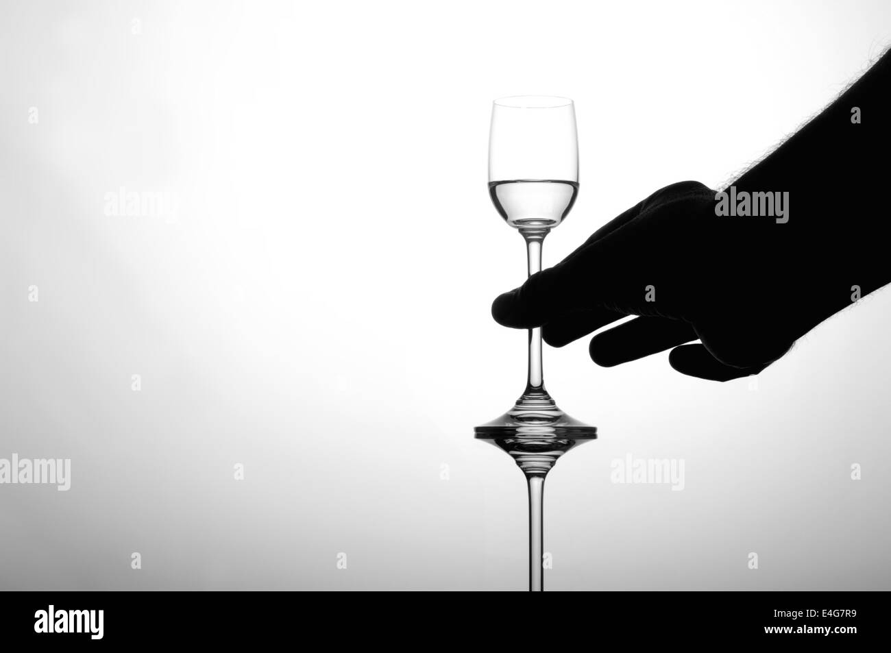 Mans hand holding liquor glass Stock Photo