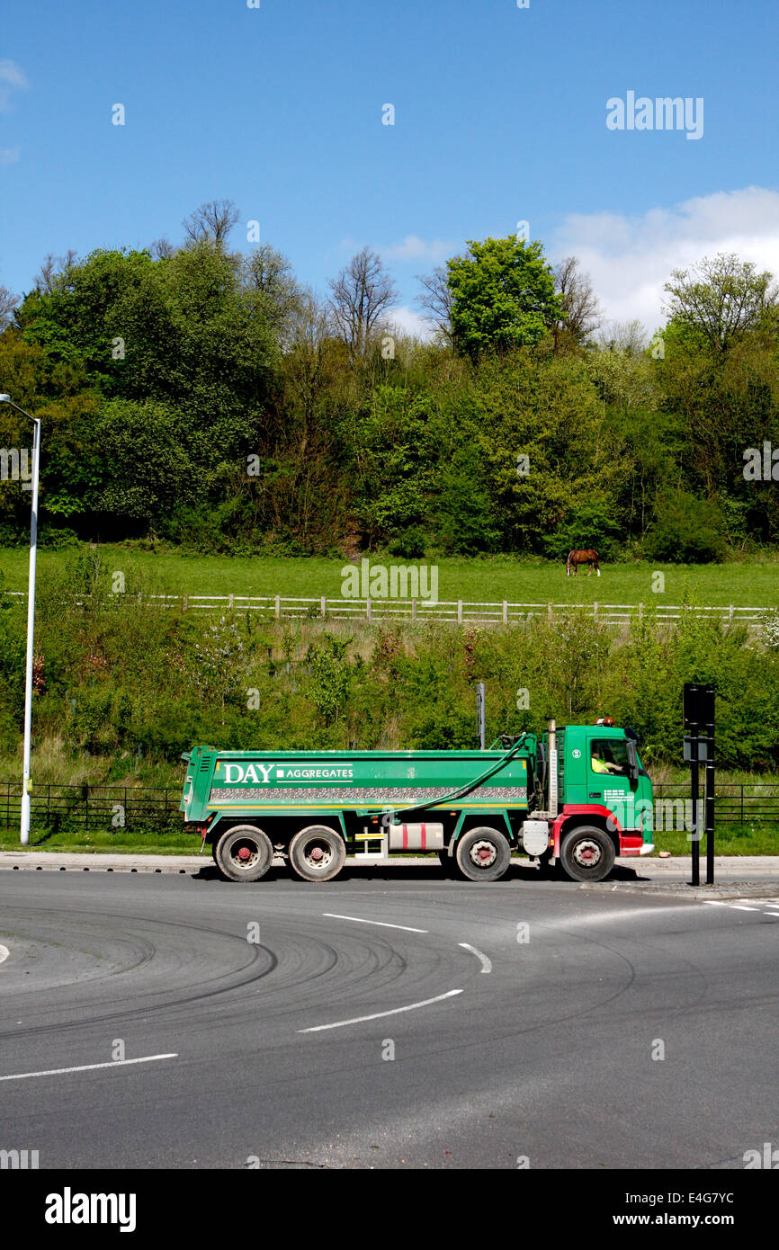 A Day Aggregates tipper truck traveling around a roundabout in Coulsdon, Surrey, England Stock Photo