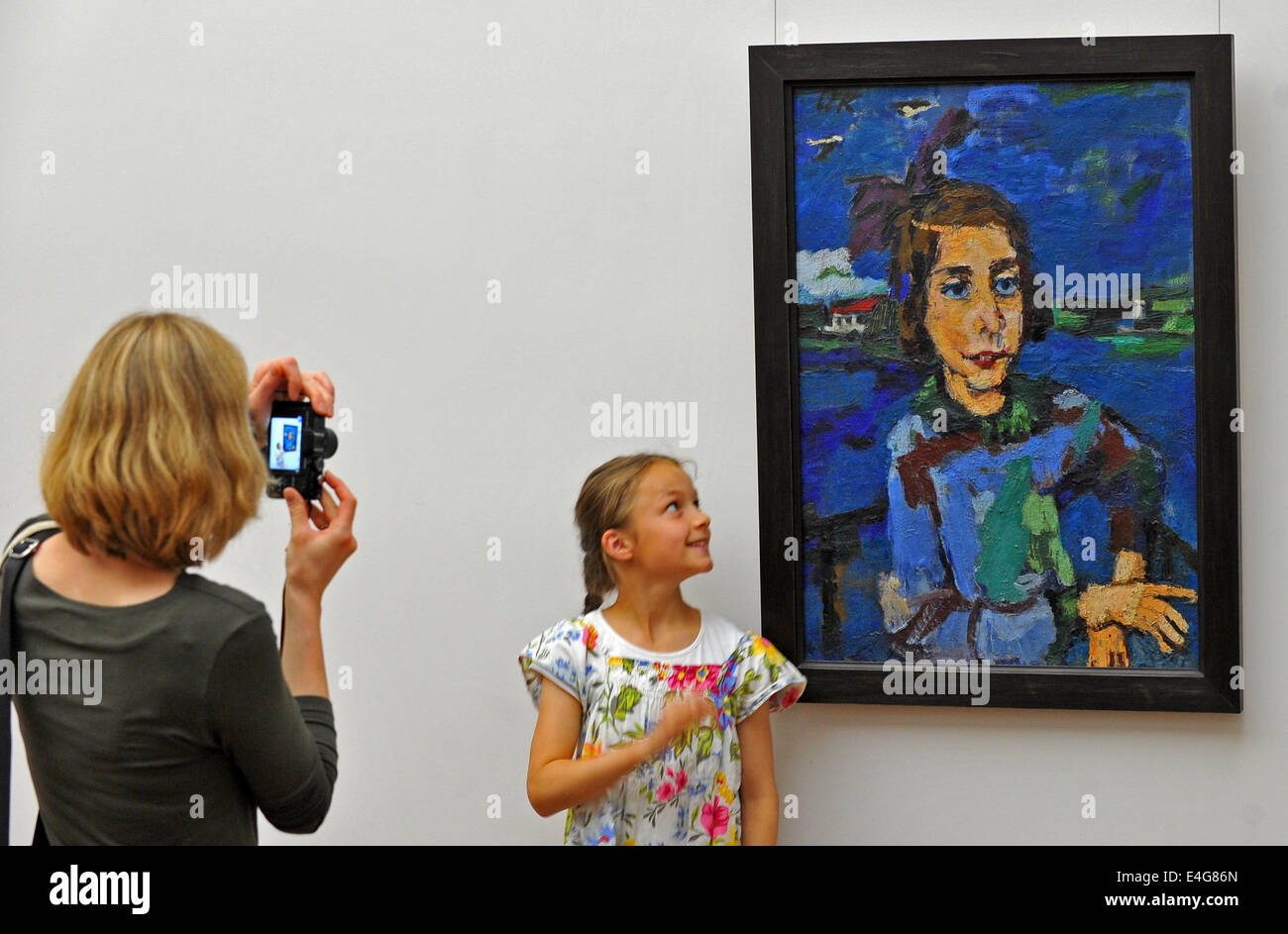 A girl poses next to the painting 'Gitta Wallerstein' from the year 1921 by Oskar Kokoschka (1886-1980) at the Galerie Neue Meister (lit. New Masters Gallery) in Dresden, Germany, 10 July 2014. The Gallery purchased the painting for 2,6 million Euro from a private owner. Photo: MATTHIAS HIEKEL/dpa Stock Photo