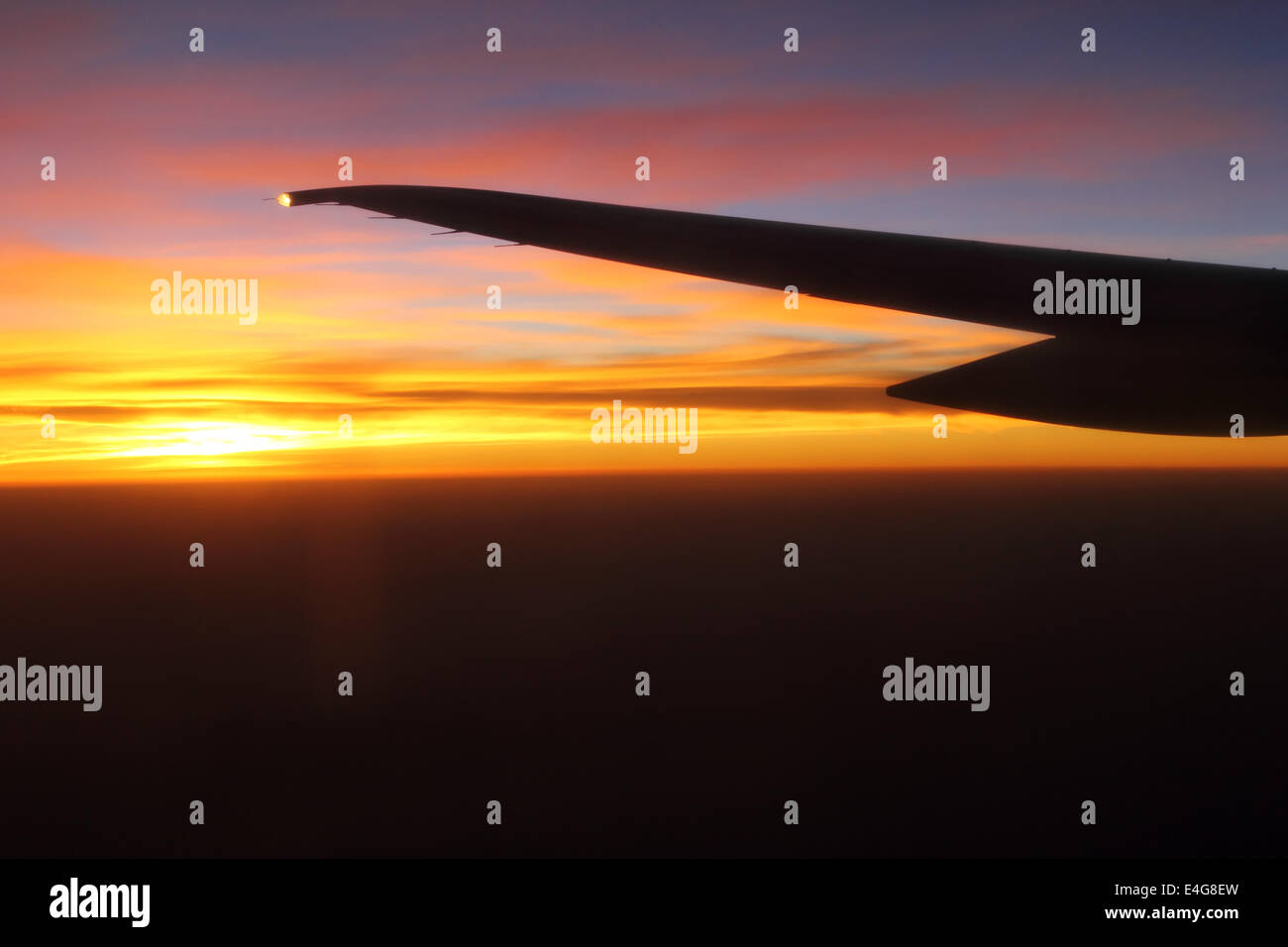 Silhouette of an airplane wing against the sunrise Stock Photo