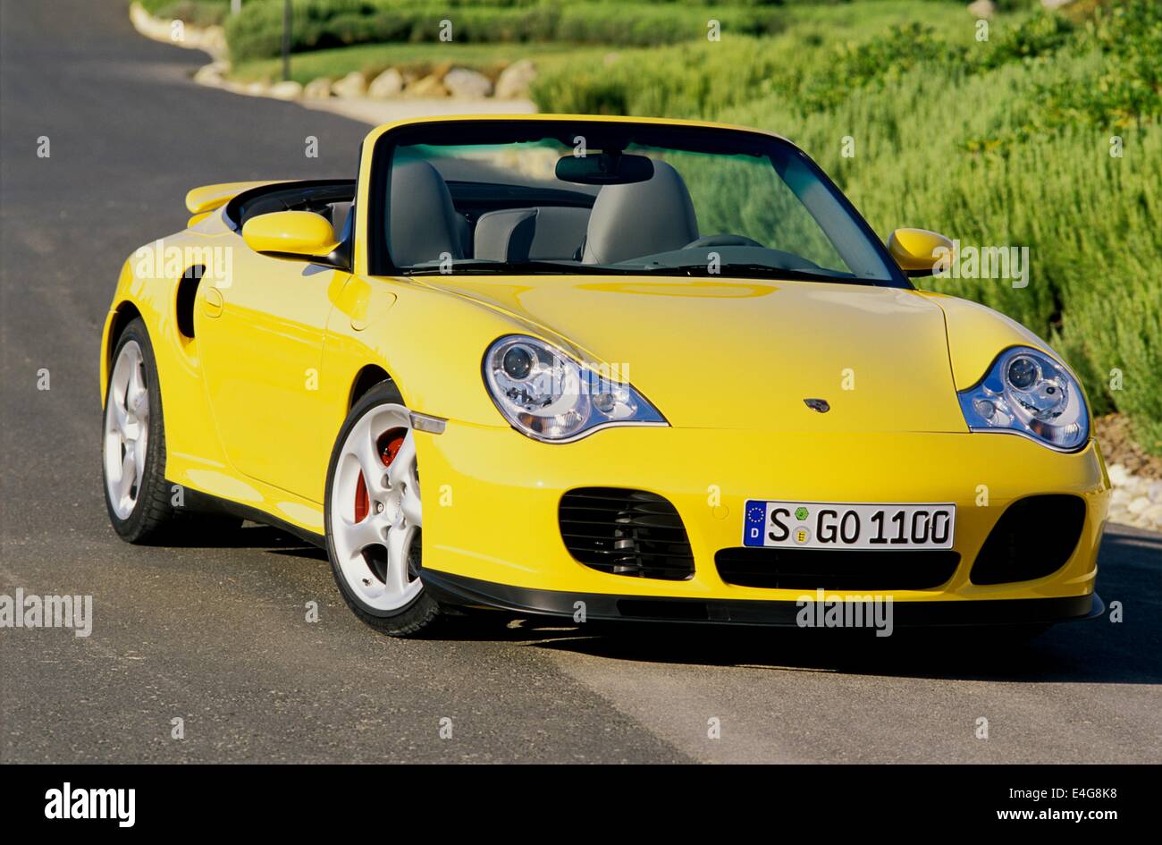 Porsche 911 Carrera 4S - 996 Varient - Cabriolet Version in Yellow  convertible - showing front and side view with roof down Stock Photo - Alamy
