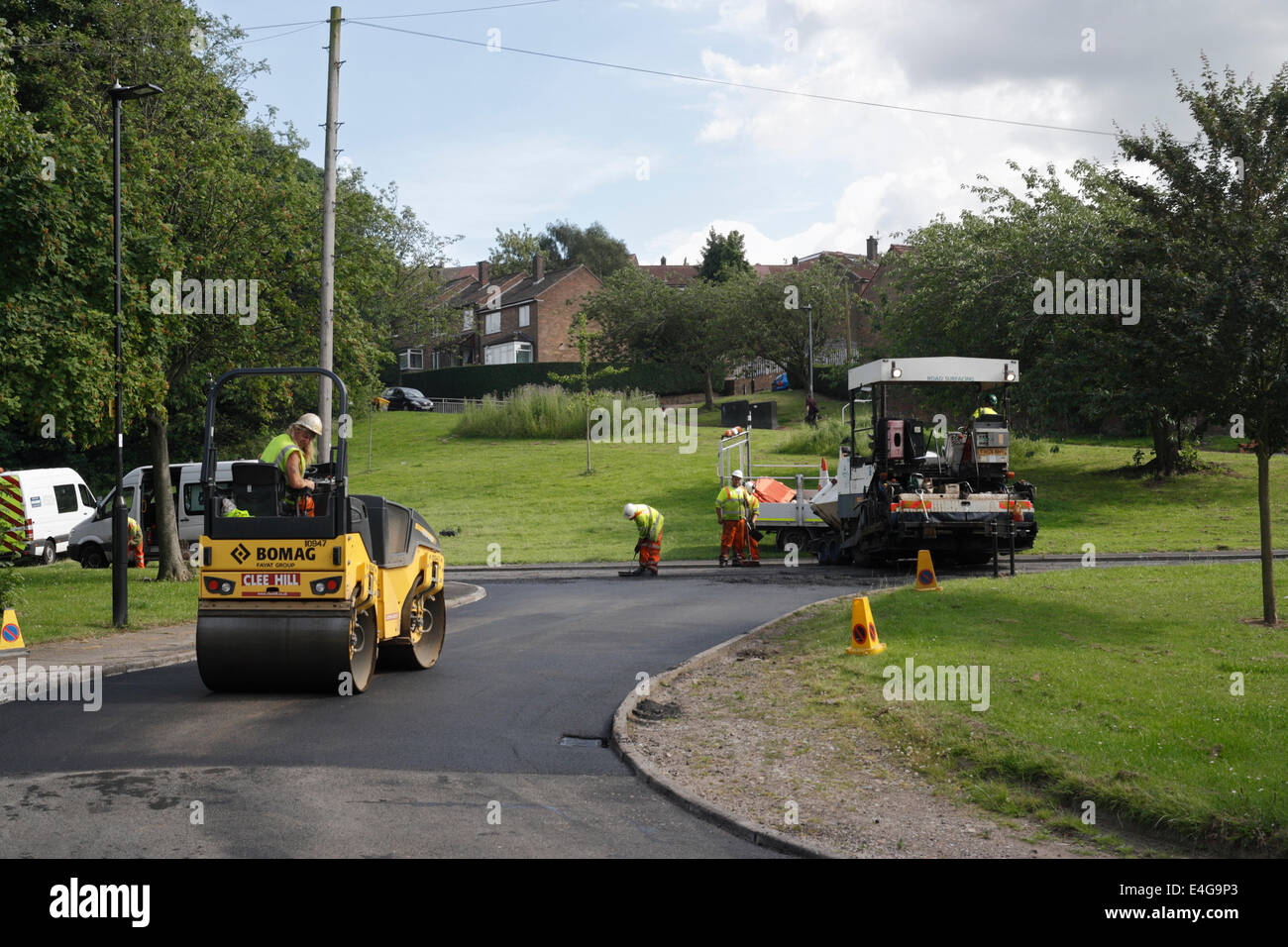 Road resurfacing work in a suburban street in Sheffield England. Men working road repairs Stock Photo