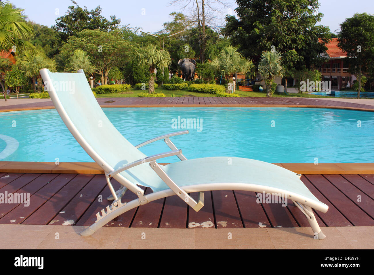 lounge chairs in a swimming pool invite you to relax Stock Photo