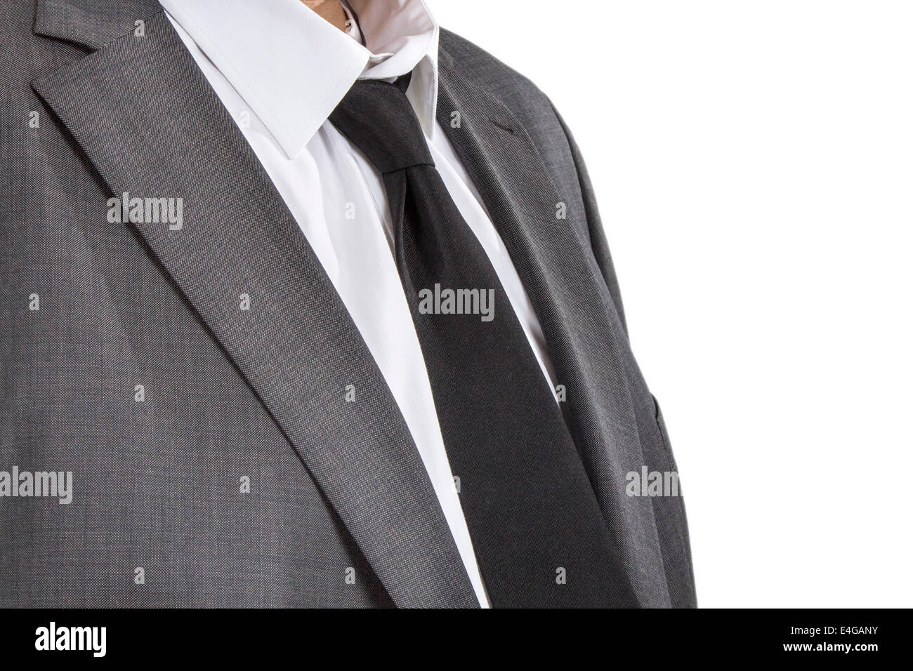 Detail of a man wearing a suite with white shirt and black tie Stock