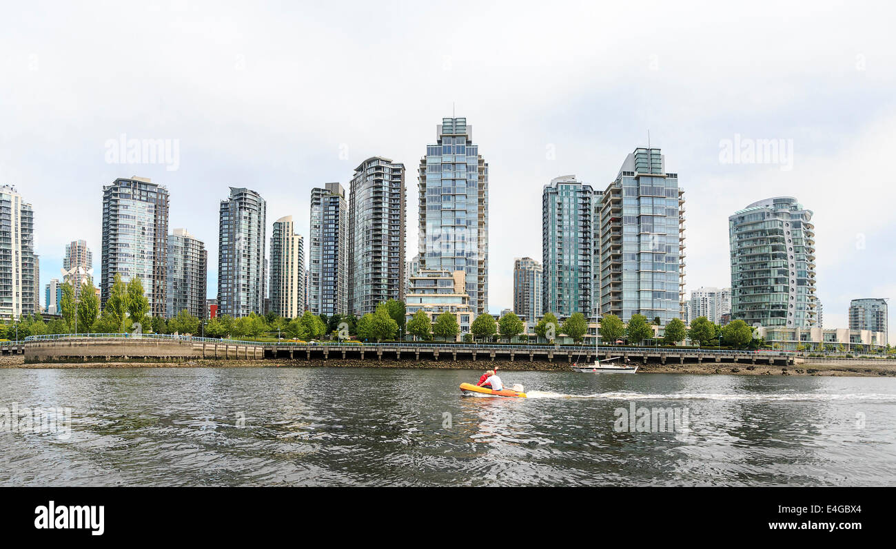 City skyline of Vancouver, British Columbia, Canada, as seen from the water. Famous curved building is in view on right. Stock Photo