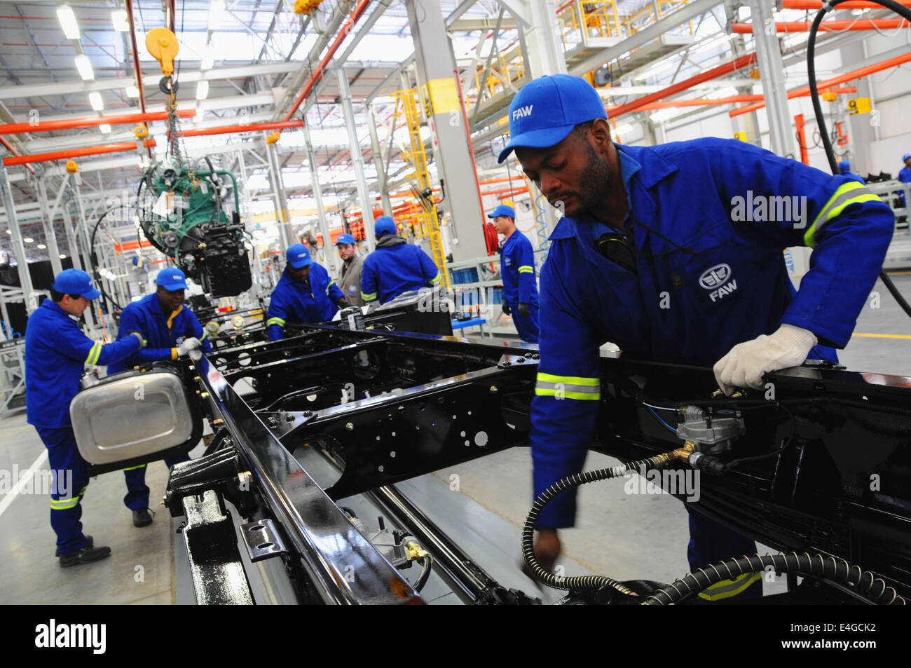 Nelson Mandela, South Africa. 10th July, 2014. Workers work in new assembly production plant of China First Automotive Works (FAW) Group Corporation in Nelson Mandela Bay Municipality, South Africa, July 10, 2014. China FAW Group Corporation launched its new assembly production plant in COEGA Industrial Development Zone (IDZ) in the Nelson Mandela Bay Municipality on Thursday. The plant, with an investment of 57 million dollars will initially assemble 5,000 trucks annually for the Sub-Saharan African market. © Zhang Chuanshi/Xinhua/Alamy Live News Stock Photo