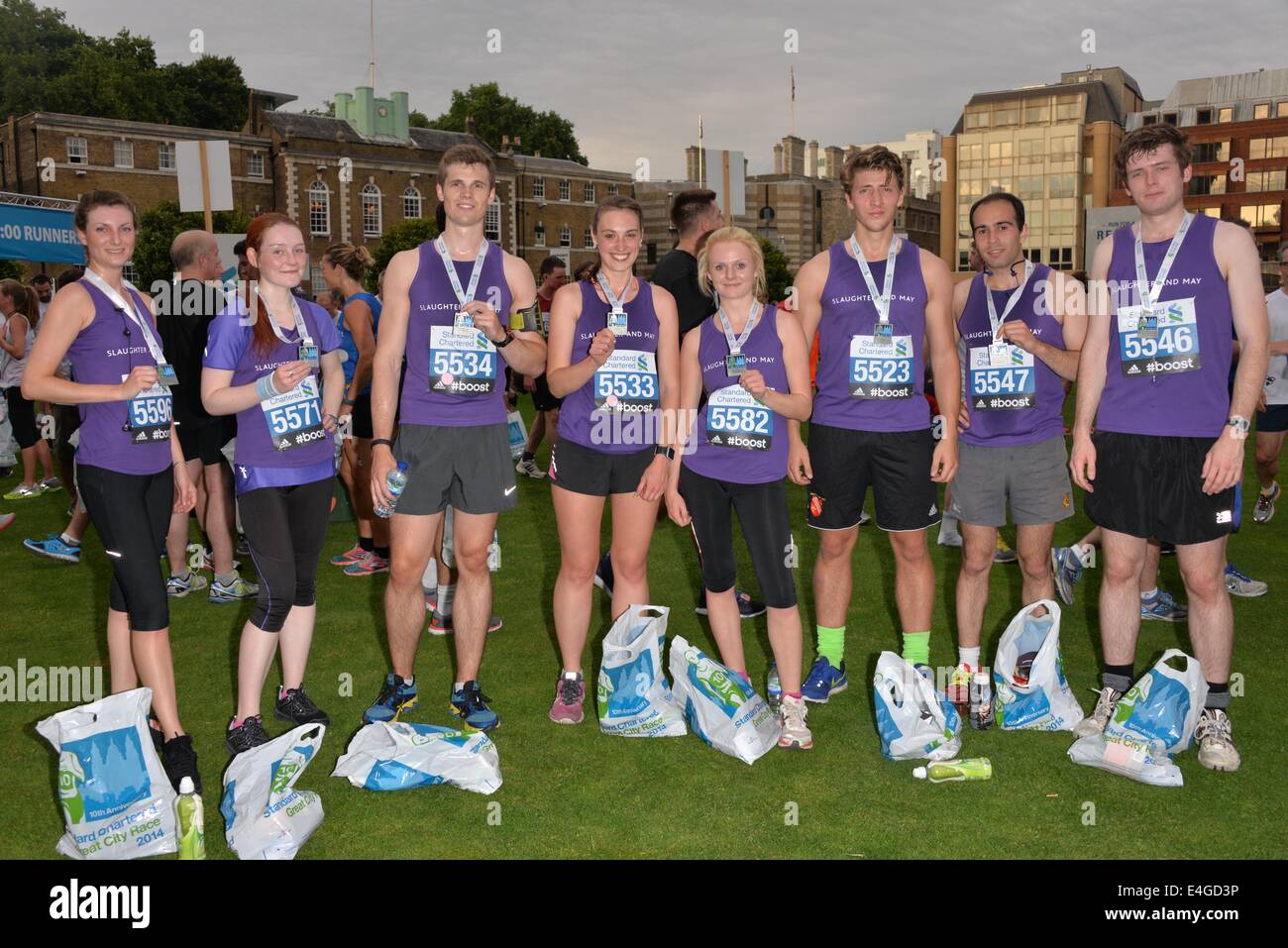 London, UK. 10th July, 2014. Proud runner finish the Standard Chartered Great City Race 2014 receive a metal in London. Credit:  See Li/Alamy Live News Stock Photo