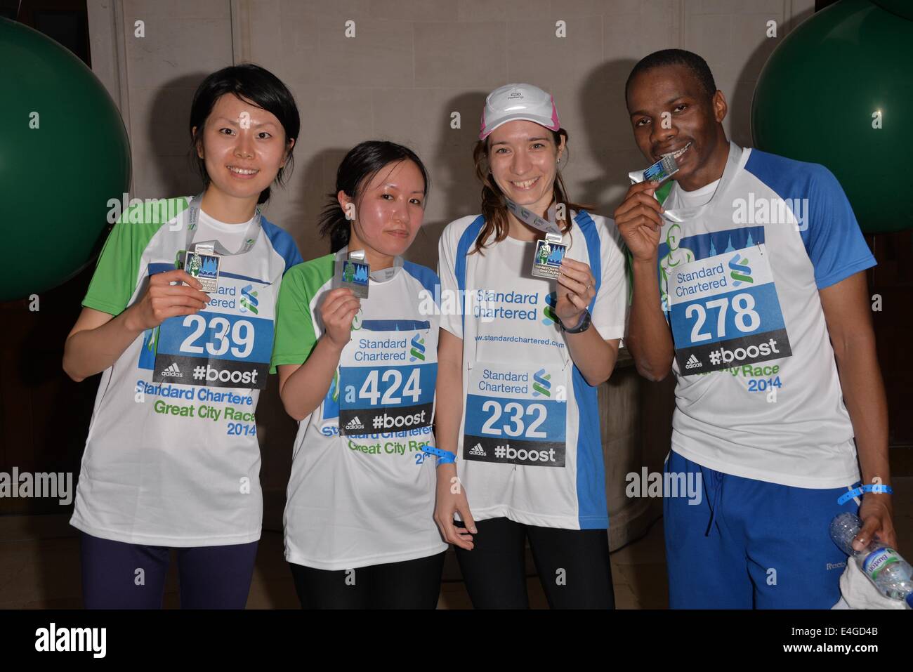 London, UK. 10th July, 2014. Proud runner finish the Standard Chartered Great City Race 2014 receive a metal in London. Credit:  See Li/Alamy Live News Stock Photo