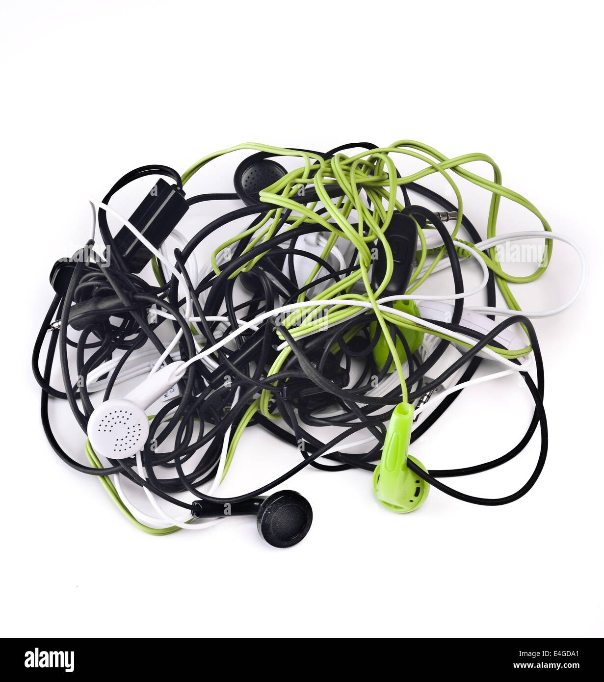 Twisted headphones, of different colors, on white background. Stock Photo