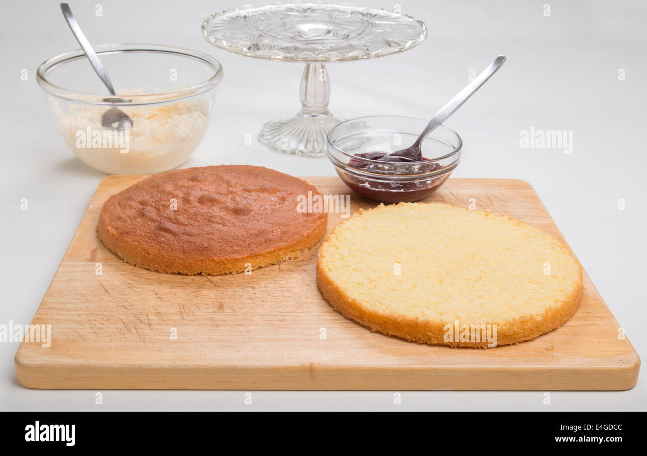 a victoria sponge cake sliced ready to add jam and butter cream  [Land] 'making a cake' (25 of 44) Stock Photo