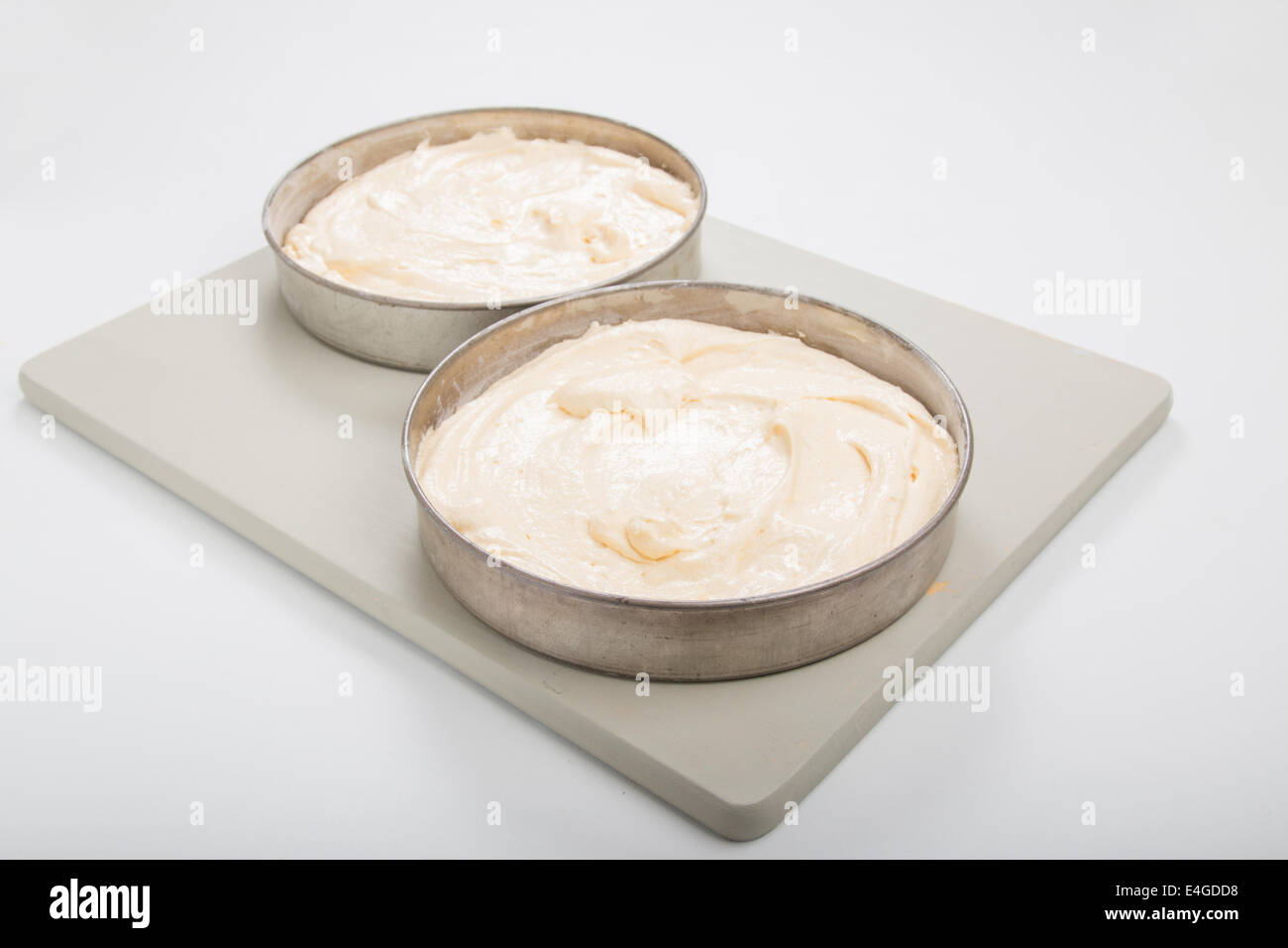 victoria sponge cake batter in 2 round tin/pans ready to cook [CO