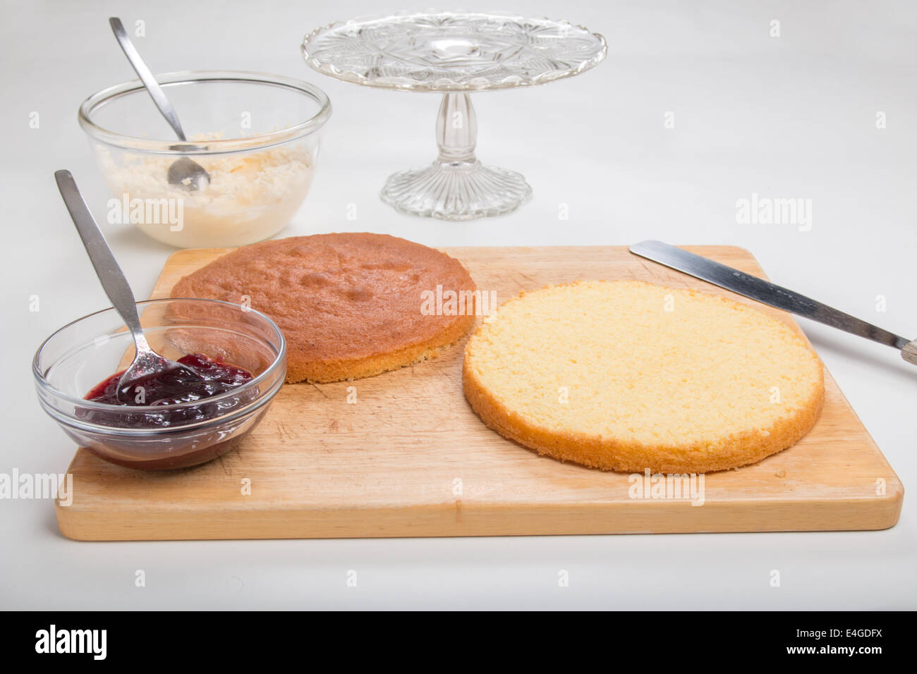 a victoria sponge cake sliced ready to add jam and butter cream  [Land] 'making a cake' (26 of 44) Stock Photo