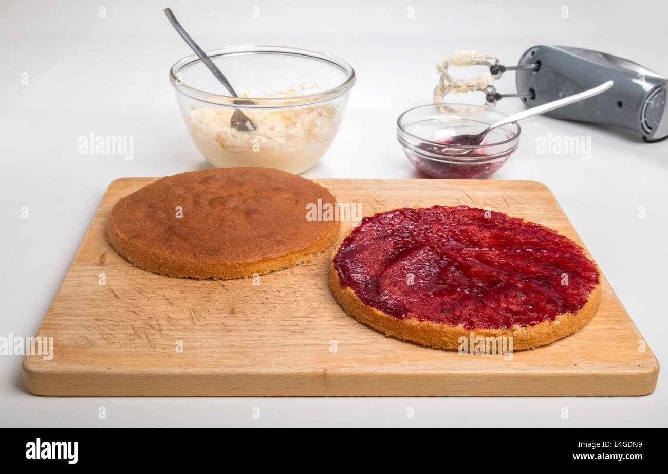 victoria sponge sliced, jam spread,ready for butter cream [Land] 'making a cake'  (27 of 44) Stock Photo